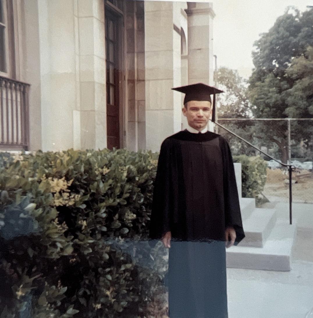 A person wearing a graduation cap and gown

Description automatically generated with medium confidence